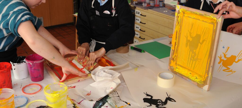 Participants engaging in a screen printing activity.