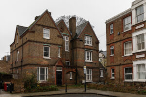 Street view of an old vicarage on a quiet British road