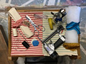 Flat lay depicting various materials and tools used in upholstery