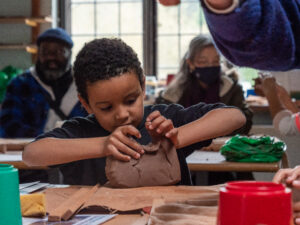 Young boy working with terracotta.