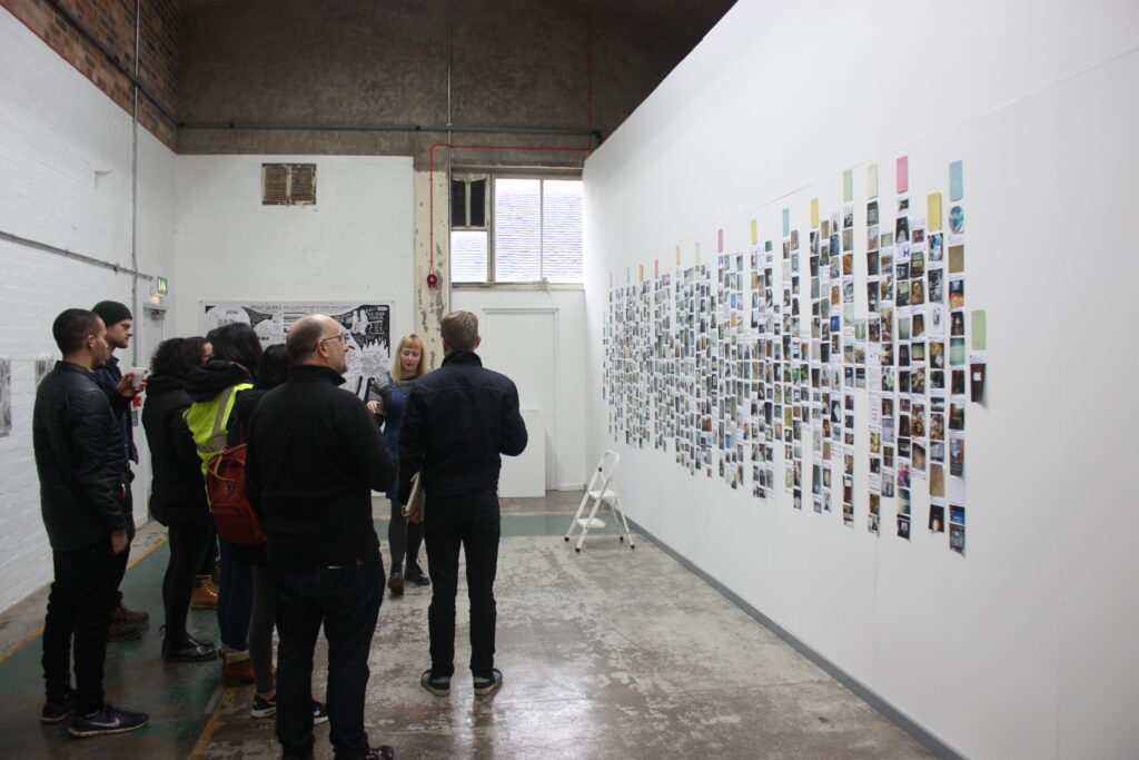 A group of people attending an event at an art exhibition