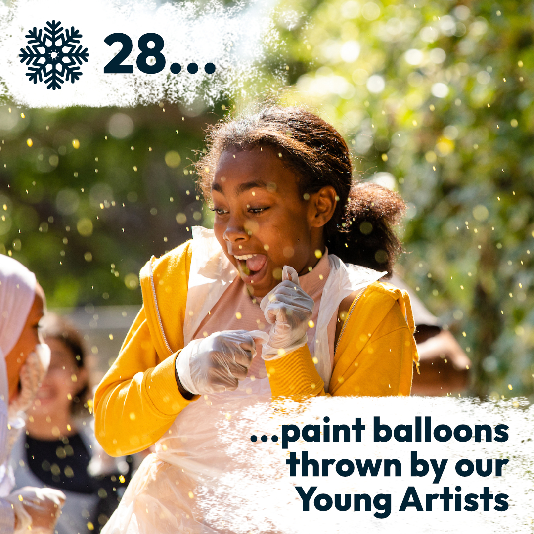Close-up of a child excitedly flinching away at paint splashes.
