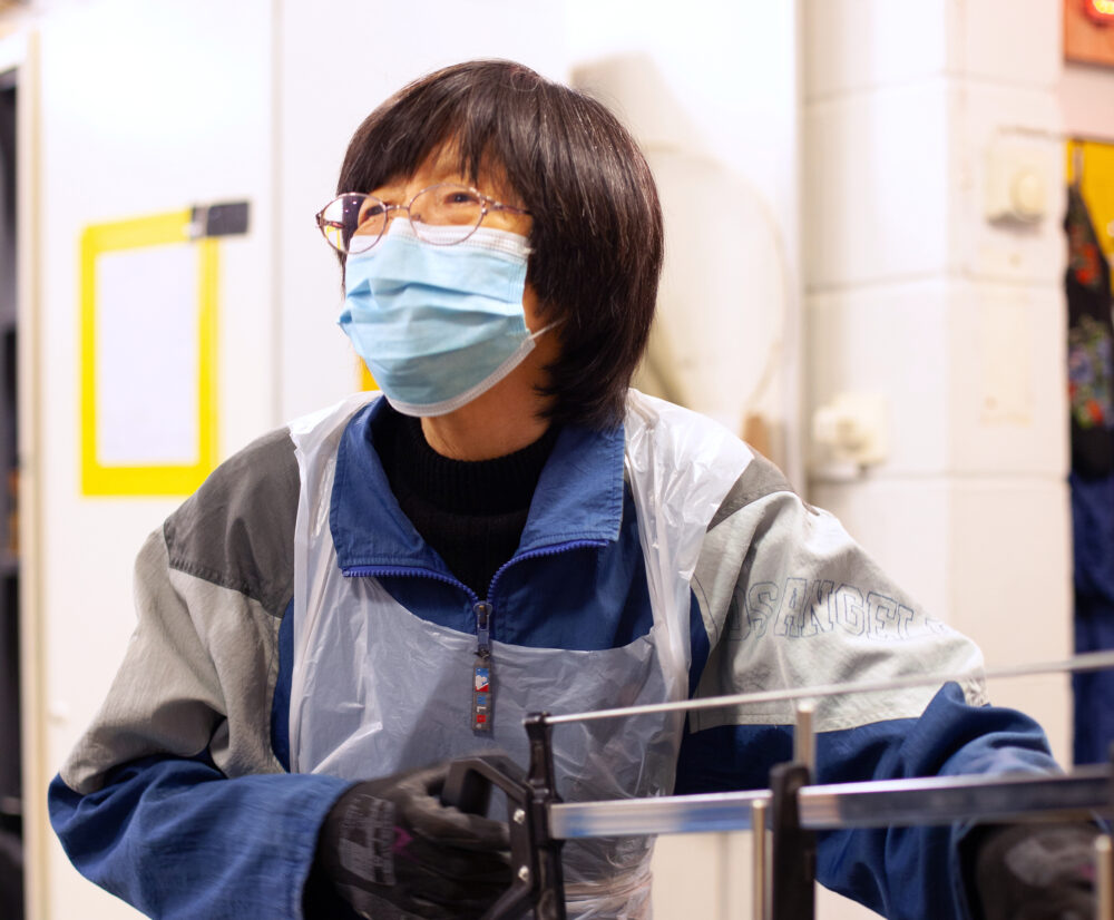 Closeup of a person using carpentry tools in a bright makerspace, indoors.